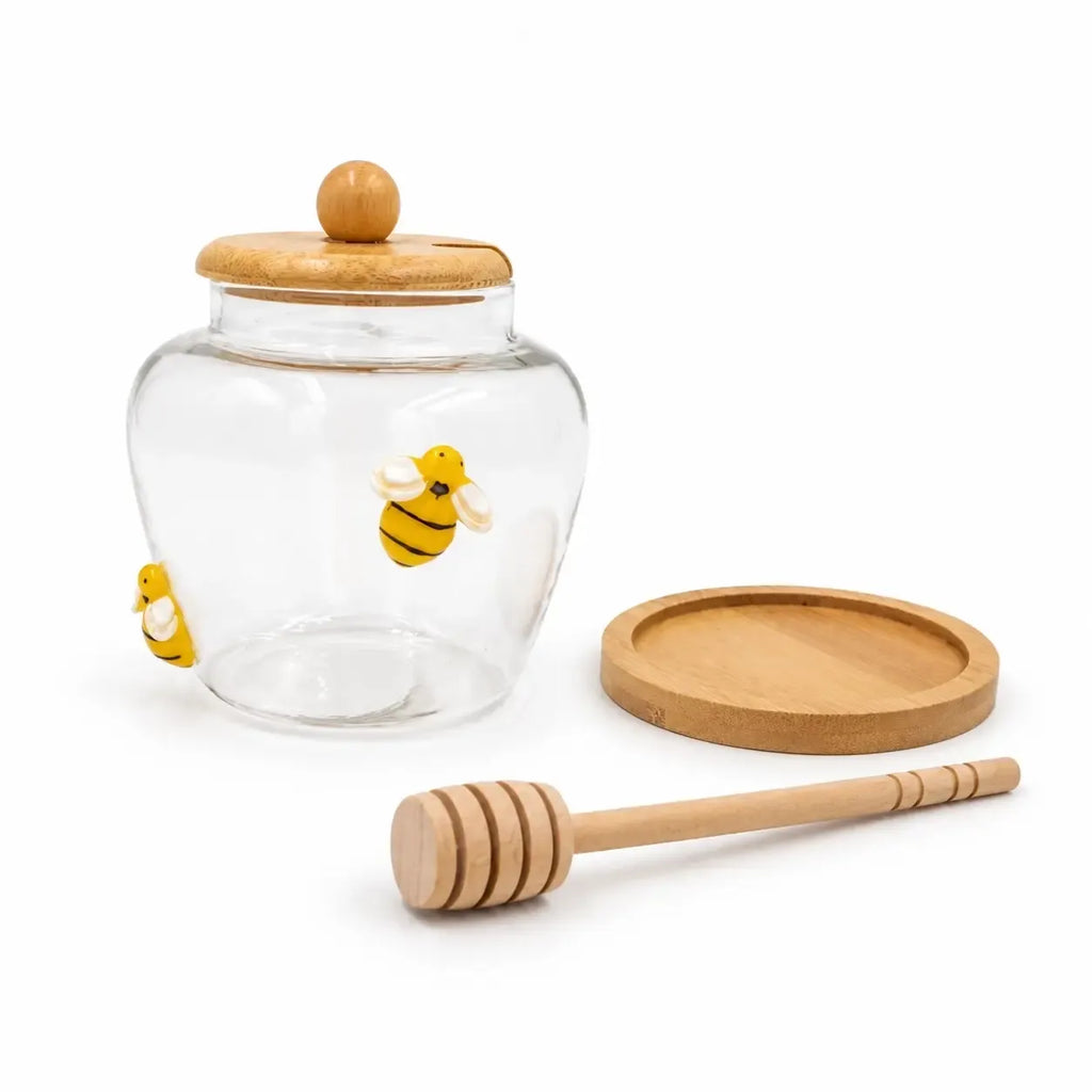Stiklinis medaus indelis su mediniu šaukšteliu, 450 ml, aiškiai matomas skaidrus stiklas ir natūralus medinis šaukštelis.